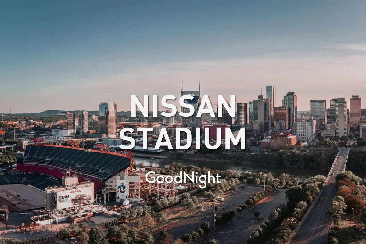 This dynamic exterior scene captures Nissan Stadium in the foreground, with Nashville's iconic city skyline and the winding river setting the backdrop. Crowds can be seen enjoying the vibrant atmosphere, hinting at the area's energetic events and entertainment options.