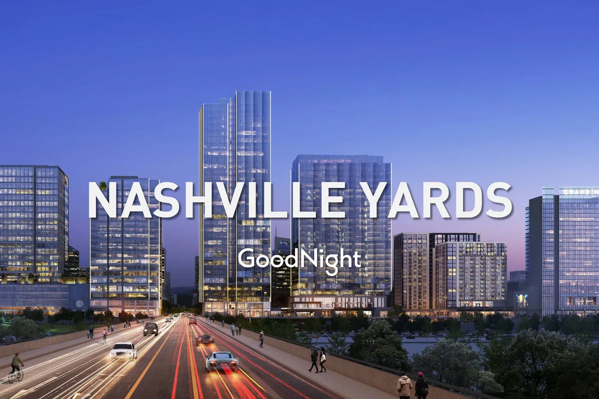 A bustling cityscape featuring modern skyscrapers and a busy road, capturing the energetic spirit of Nashville. The lively evening atmosphere hints at nearby restaurants, shopping, and nightlife just minutes from the property.